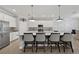 Modern kitchen island featuring barstool seating, elegant pendant lighting and ample cabinets at 13587 Vancanza Dr, Venice, FL 34293