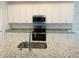 The kitchen island boasts granite countertops, a stainless steel sink, and white cabinets at 13587 Vancanza Dr, Venice, FL 34293