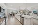 Bright, open kitchen with large island, stainless appliances, and seamless flow to living spaces at 13587 Vancanza Dr, Venice, FL 34293