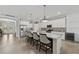 Modern kitchen with large island, bar seating, stainless steel appliances, and plenty of cabinet space at 13587 Vancanza Dr, Venice, FL 34293