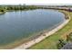Expansive lake view, showcasing serene water and lush greenery, enhancing the property's appeal at 13587 Vancanza Dr, Venice, FL 34293