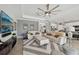 Comfortable living room featuring a contemporary ceiling fan and open access to the kitchen and dining at 13587 Vancanza Dr, Venice, FL 34293