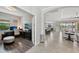 Open-concept living space with tiled floors and seamless flow to dining and kitchen areas at 13587 Vancanza Dr, Venice, FL 34293