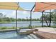 Relaxing screened pool and spa with sunshades create a tranquil oasis, perfect for unwinding outdoors with a water view at 13587 Vancanza Dr, Venice, FL 34293