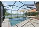 Gorgeous screened-in pool area with a spa and peaceful lake views, perfect for relaxation at 13587 Vancanza Dr, Venice, FL 34293