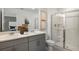 Bathroom featuring double sinks, a glass-enclosed shower, and a large mirror at 15153 Cuzcorro Ct, Nokomis, FL 34275