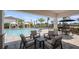 Covered poolside seating area offering shade and relaxation with comfortable chairs at 15161 Cuzcorro Ct, Nokomis, FL 34275