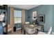 Home office with desk, shelves and artwork in calming blue tones at 15165 Cuzcorro Ct, Nokomis, FL 34275
