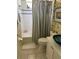 Bright bathroom with tiled shower, vanity, unique bowl sink, and stylish patterned wallpaper at 1620 San Silvestro Dr, Venice, FL 34285