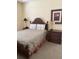 Cozy bedroom with wicker headboard, decorative pillows, and two accent tables with lamps at 1620 San Silvestro Dr, Venice, FL 34285