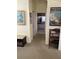 Bright hallway leads to bathroom with unique decor, including a travel poster and decorative accents at 1620 San Silvestro Dr, Venice, FL 34285
