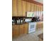 Functional kitchen features wood cabinets, tiled backsplash, modern appliances, and lots of storage at 1620 San Silvestro Dr, Venice, FL 34285