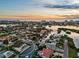 Beautiful sunset aerial view of the waterfront home with private pool and access to the bay and Gulf of Mexico at 1643 Stanford Ln, Sarasota, FL 34231