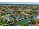 An aerial view of the home shows waterfront access and a backyard featuring a pool and a lounge area at 1643 Stanford Ln, Sarasota, FL 34231
