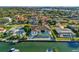 Waterfront home with a pool and a boat dock on the canal and other beautiful homes in the distance at 1643 Stanford Ln, Sarasota, FL 34231