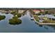 An aerial view captures the waterfront property, complete with boat docks, residential buildings, and lush mangrove islands at 1643 Stanford Ln, Sarasota, FL 34231