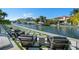The backyard features waterfront views, modern chairs, and manicured landscaping, creating an inviting outdoor living space at 1643 Stanford Ln, Sarasota, FL 34231