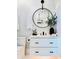 Elegant bathroom features a modern vanity, round mirror, and stylish lighting at 1643 Stanford Ln, Sarasota, FL 34231