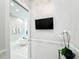 Luxurious bathroom showcasing a soaking tub, tiled walls, and wall-mounted television at 1643 Stanford Ln, Sarasota, FL 34231