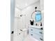 This bathroom has a modern vanity with black hardware and a glass enclosed walk-in shower at 1643 Stanford Ln, Sarasota, FL 34231