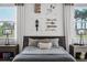 Stylish bedroom with unique wall art, windows offering natural light, and contemporary lamps at 1643 Stanford Ln, Sarasota, FL 34231