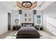 Stylish bedroom featuring a unique light fixture, two large windows, and modern decor at 1643 Stanford Ln, Sarasota, FL 34231