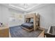 Bright bedroom featuring a unique bunk bed with a desk, piano, and hardwood floors at 1643 Stanford Ln, Sarasota, FL 34231