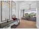 Inviting entryway featuring decor, mirrors, and views into the stylish living room and outdoor pool at 1643 Stanford Ln, Sarasota, FL 34231