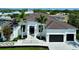 Beautiful two-story home with manicured landscaping, a three-car garage, and a grand entrance at 1643 Stanford Ln, Sarasota, FL 34231