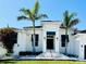 Stunning home exterior featuring a grand entrance, manicured lawn, and lush landscaping at 1643 Stanford Ln, Sarasota, FL 34231