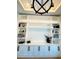 Custom shelving with built-in cabinets for storage and display in the modern, well-lit home office at 1643 Stanford Ln, Sarasota, FL 34231