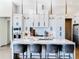 Modern kitchen with a large island, white cabinets, stainless steel appliances, and counter seating at 1643 Stanford Ln, Sarasota, FL 34231