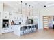 Gourmet kitchen features stainless steel appliances, an island with seating, and custom white cabinets at 1643 Stanford Ln, Sarasota, FL 34231
