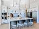 Bright, spacious kitchen featuring a large island, white cabinets, stainless appliances, and counter seating at 1643 Stanford Ln, Sarasota, FL 34231