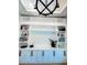 Spacious living room with custom built-in shelving and cabinets with contrasting hardware at 1643 Stanford Ln, Sarasota, FL 34231
