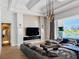 An open concept living room with fireplace, TV, and sliding doors to the outdoor pool at 1643 Stanford Ln, Sarasota, FL 34231