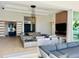 Elegant living room features a fireplace, modern lighting, and sliding glass doors to outdoor area at 1643 Stanford Ln, Sarasota, FL 34231