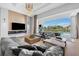 Sophisticated living room with sleek fireplace, TV, and sliding doors to the outdoor pool area at 1643 Stanford Ln, Sarasota, FL 34231