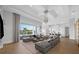 Spacious living room with sliding doors to the pool deck and views of the modern, eat-in kitchen at 1643 Stanford Ln, Sarasota, FL 34231