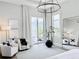 Serene main bedroom with a seating area, neutral decor, and views of the outdoor pool area at 1643 Stanford Ln, Sarasota, FL 34231