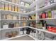 Well-organized pantry with white shelving and various food and small appliances, offering ample storage at 1643 Stanford Ln, Sarasota, FL 34231
