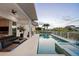 An outdoor pool is set against the backdrop of the house, with a patio, and view of the waterway beyond at 1643 Stanford Ln, Sarasota, FL 34231