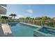 Outdoor pool with attached jacuzzi overlooking lush landscaping at 1643 Stanford Ln, Sarasota, FL 34231