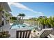 Enjoy poolside relaxation with a built-in spa, outdoor kitchen, and stunning views at 1643 Stanford Ln, Sarasota, FL 34231