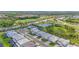 An aerial view of an upscale neighborhood showcases manicured landscaping, modern homes, and a golf course at 16434 Slate Pl, Bradenton, FL 34211