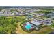 Aerial view shows a community pool, playground and landscaping for an active community at 16434 Slate Pl, Bradenton, FL 34211