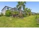 Spacious green backyard with a screened-in pool area and lush tropical landscaping at 16434 Slate Pl, Bradenton, FL 34211