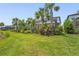 Lush backyard with a screened-in lanai, mature trees, and well-maintained lawn at 16434 Slate Pl, Bradenton, FL 34211