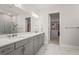 Modern bathroom with double vanity, marble floors, and a walk-in closet at 16434 Slate Pl, Bradenton, FL 34211