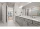 Elegant bathroom featuring double sinks with marble countertops and tile flooring at 16434 Slate Pl, Bradenton, FL 34211